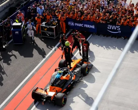 Lando Norris of McLaren celebrates his win on arrival in parc ferme.