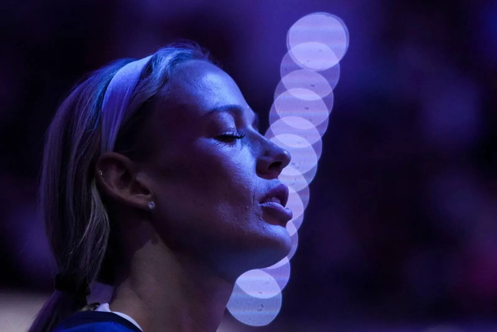 Indiana Fever guard Sophie Cunningham closes her eyes while listening to the National Anthem before a game.