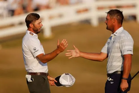Sam Burns shakes hands with Bryson DeChambeau after the third round