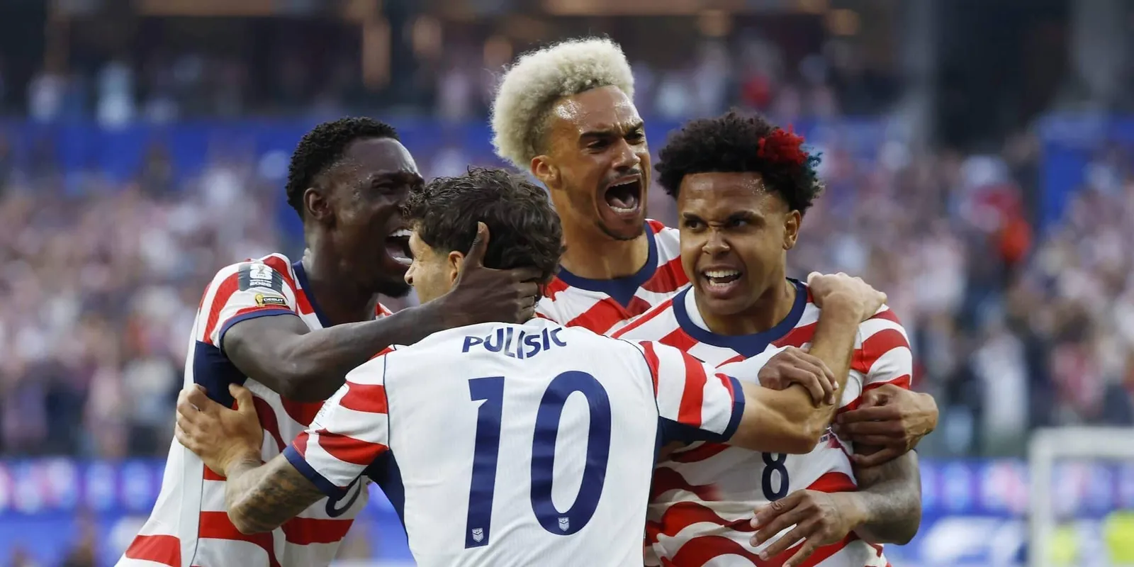 USMNT players celebrate together after scoring at the World Cup