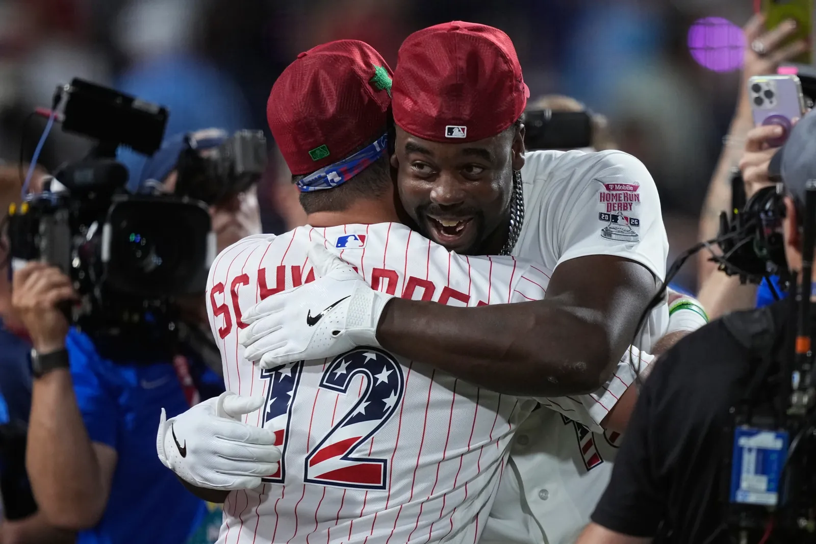 St. Louis Cardinals' Jordan Walker embraces Philadelphia Phillies' Kyle Schwarber after Walker won the MLB baseball All-Star Home Run Derby, Monday, July 13, 2026, in Philadelphia. (AP Photo/Matt Slocum)