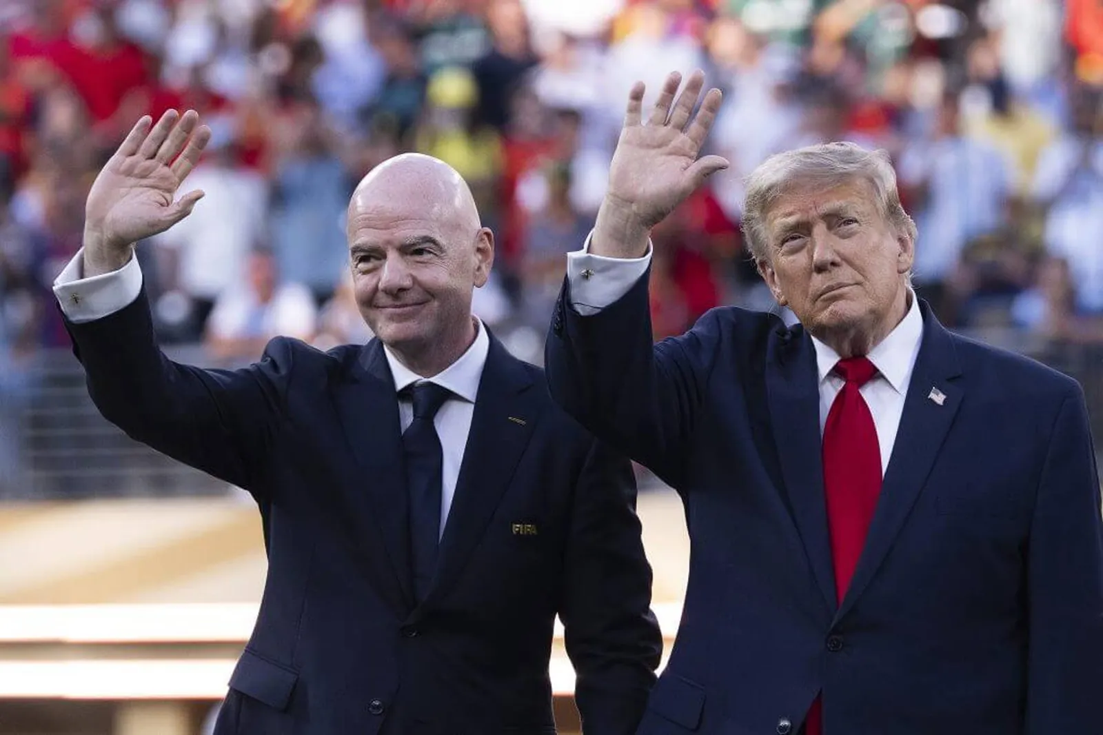 Image of Gianni Infantino and Donald Trump waving to the fans during the World Cup final