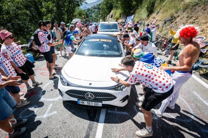 Fans get up close and personal with a car on the climb up Alpe d’Huez. (BELGA PHOTO DAVID PINTENS (Photo by DAVID PINTENS / BELGA MAG / Belga / AFP via Getty Images)